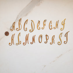 Script initial charms in gold