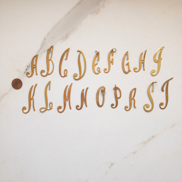 Script initial charms in gold